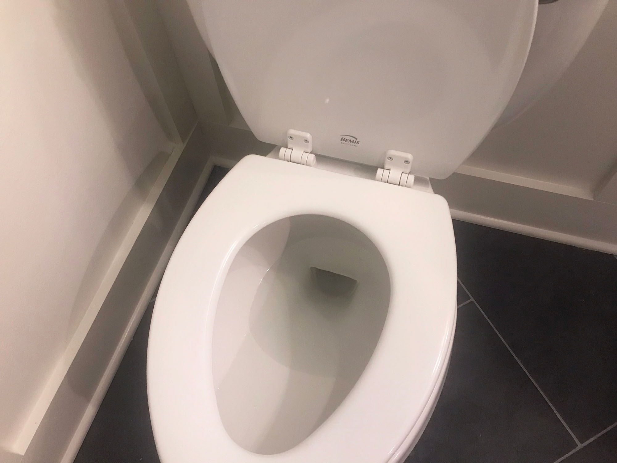 Guardian Angel toilet splash shield installed beneath toilet seat